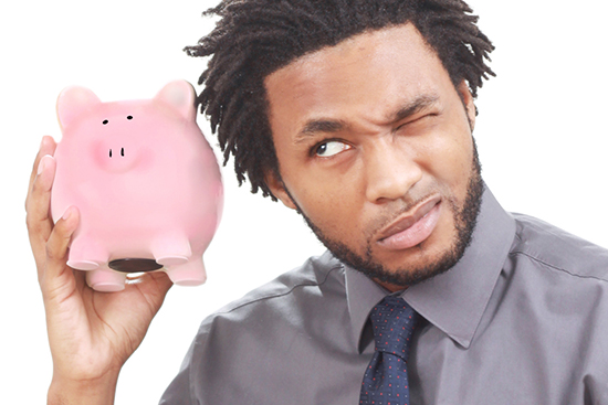 stockvault-man-shaking-a-piggy-bank127892